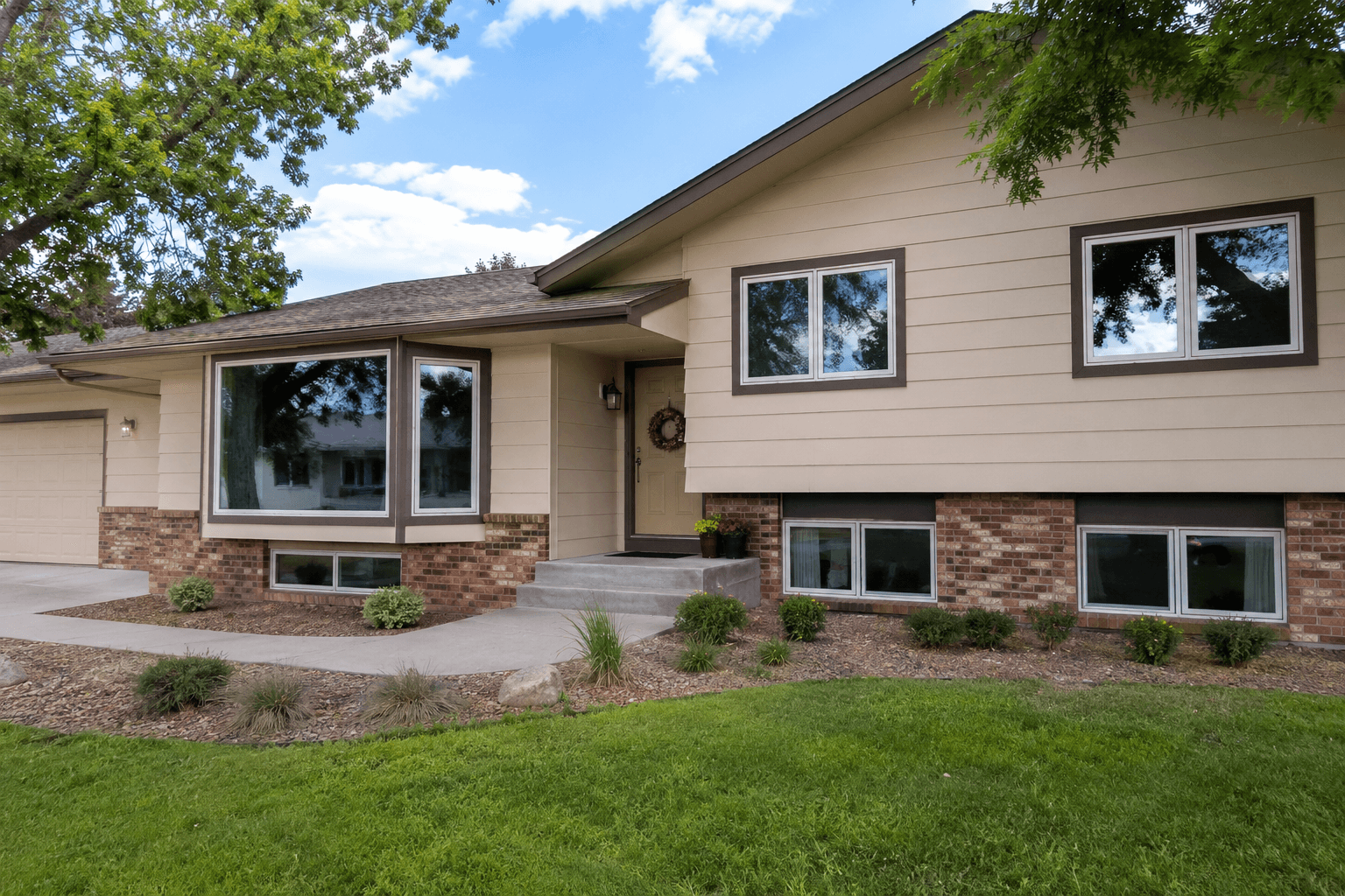 Single-story residential home exterior with clean windows and manicured landscaping